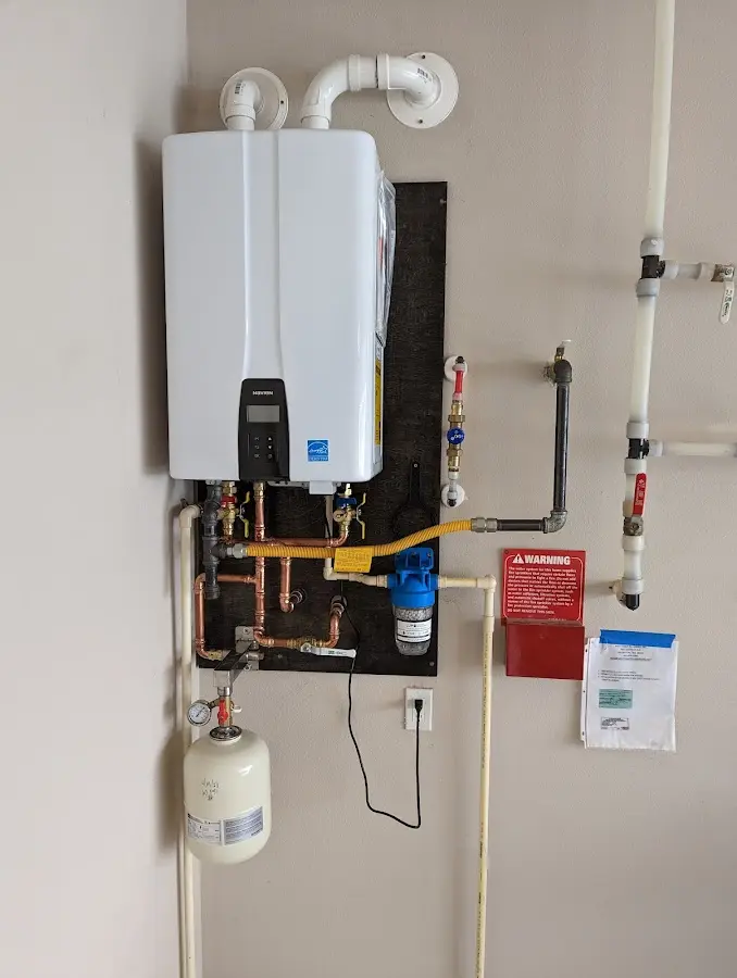 Professional plumber installing copper piping in a Perry home